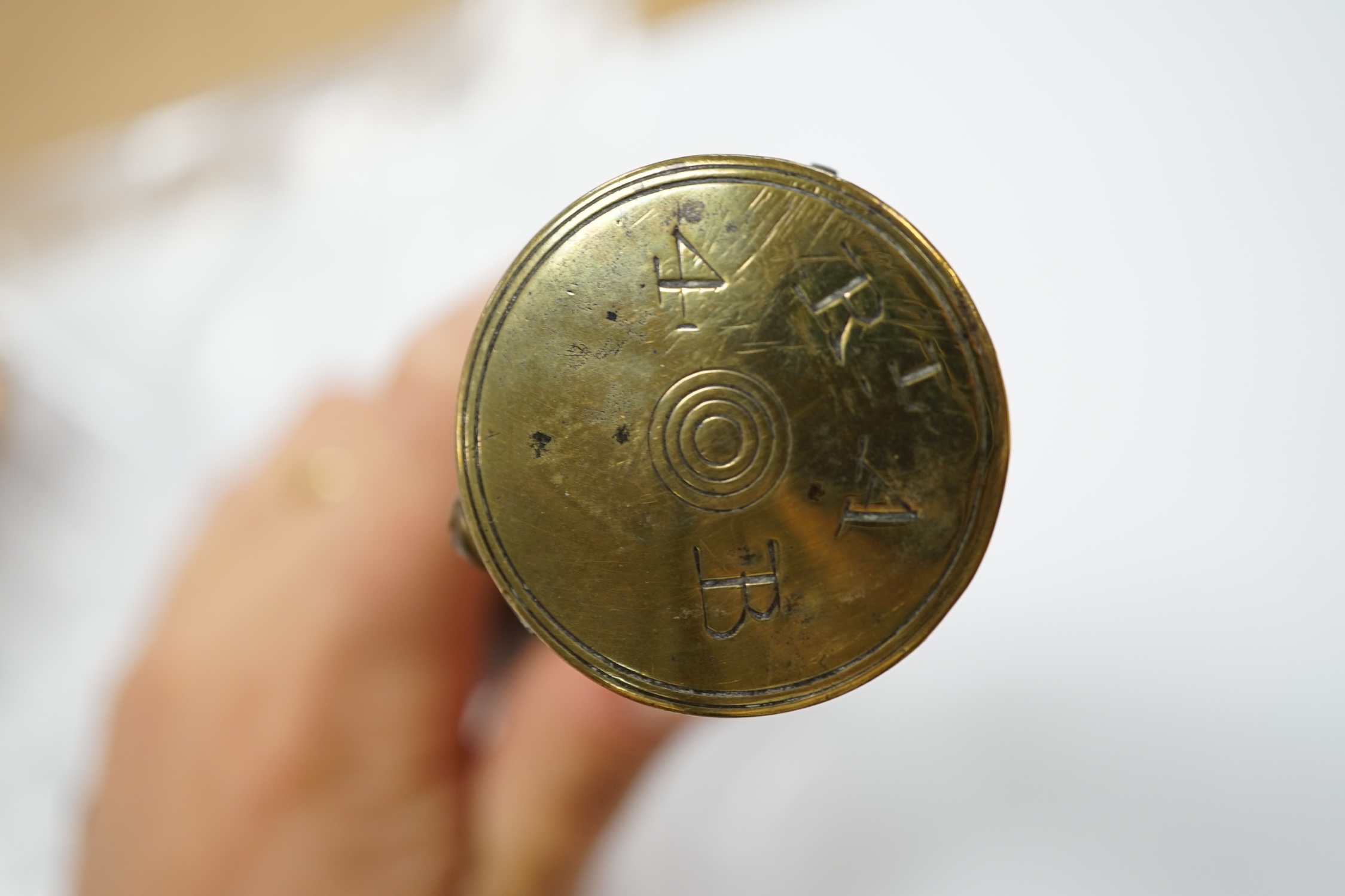 Five 19th century powder flasks; three copper and brass flasks, two with embossed decoration to the bodies, a leather covered flask and a horn Royal Artillery priming horn. Condition - poor to fair